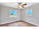 Well-lit bedroom with wood-look floors and ceiling fan at 189 Bunker Rd, Rotonda West, FL 33947