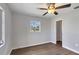 Bedroom with wood-look floors, ceiling fan and window at 189 Bunker Rd, Rotonda West, FL 33947