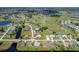 Aerial view of community with golf course and lake at 189 Bunker Rd, Rotonda West, FL 33947