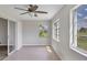 Bright sunroom with tile flooring, ceiling fan, and sliding glass doors at 189 Bunker Rd, Rotonda West, FL 33947