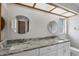 Bathroom boasts double sinks, granite countertops, and large mirrors at 189 Bunker Rd, Rotonda West, FL 33947