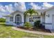 Front view of a charming house with a screened-in porch at 189 Bunker Rd, Rotonda West, FL 33947