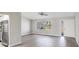 Living room with hardwood floors, large window, and access to kitchen at 189 Bunker Rd, Rotonda West, FL 33947