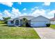 Single-story home with a two-car garage and landscaped yard at 189 Bunker Rd, Rotonda West, FL 33947