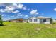 Spacious backyard with grassy area and home view at 189 Bunker Rd, Rotonda West, FL 33947
