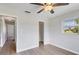 Bright bedroom with wood-look floors, ceiling fan, and access to closet at 189 Bunker Rd, Rotonda West, FL 33947