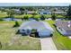 An aerial view of a single-story house with a large yard at 189 Bunker Rd, Rotonda West, FL 33947