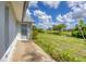 Back patio with view of grassy backyard and canal at 189 Bunker Rd, Rotonda West, FL 33947