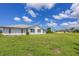 Large backyard with green grass and home view at 189 Bunker Rd, Rotonda West, FL 33947