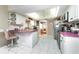 Bright kitchen features white cabinets, pink countertops, and stainless steel appliances at 1867 Neptune Dr, Englewood, FL 34223