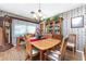 Bright dining room featuring a wooden table, and hardwood floors at 1867 Neptune Dr, Englewood, FL 34223