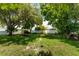 Expansive backyard with lush greenery and bird feeder at 1867 Neptune Dr, Englewood, FL 34223
