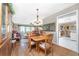 Charming dining room with a wooden table, chandelier, and hardwood floors at 1867 Neptune Dr, Englewood, FL 34223