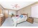 Spacious bedroom with a queen bed, wooden furniture, and ceiling fan at 1867 Neptune Dr, Englewood, FL 34223