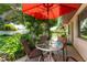 Enjoyable patio seating area with a red umbrella at 1867 Neptune Dr, Englewood, FL 34223