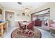 Cozy dining area with a round table and four red chairs, plus view into living room at 1867 Neptune Dr, Englewood, FL 34223