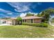 Single-story home with stone accents and a landscaped yard at 1867 Neptune Dr, Englewood, FL 34223