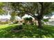 Large backyard with mature trees and landscaping at 1867 Neptune Dr, Englewood, FL 34223