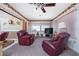 Relaxing living room with two burgundy leather recliners and a TV at 1867 Neptune Dr, Englewood, FL 34223