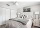 Main bedroom with a queen bed, white nightstands, and beach-themed artwork at 2350 N Beach Rd # 2A, Englewood, FL 34223