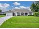 Single-story home with attached garage and manicured lawn at 38 Bunker Way, Rotonda West, FL 33947