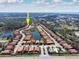 Aerial view of the real estate and the surrounding community with lush trees and lakes at 1012 Bradberry Dr, Nokomis, FL 34275