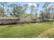 Lush backyard view shows green lawn and landscaping around the white fence at 1012 Bradberry Dr, Nokomis, FL 34275