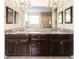 Spacious bathroom features double sinks, dark cabinets and a large vanity mirror at 1012 Bradberry Dr, Nokomis, FL 34275