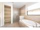 Bathroom featuring a large soaking tub, glass enclosed shower and tile flooring at 1012 Bradberry Dr, Nokomis, FL 34275