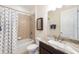 Bathroom features a shower-tub combo, toilet, and vanity with marble countertop at 1012 Bradberry Dr, Nokomis, FL 34275