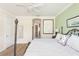 A bedroom with a white ceiling fan and a black metal bed frame with white and gray linens at 1012 Bradberry Dr, Nokomis, FL 34275