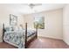 Bedroom with patterned bedspread, window, carpeted floor, and natural lighting at 1012 Bradberry Dr, Nokomis, FL 34275
