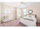 Cozy bedroom features a ceiling fan, window with blinds, and a comfortable bed with decorative pillows at 1012 Bradberry Dr, Nokomis, FL 34275