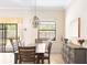 Dining room featuring a wood table set, a decorative chandelier, and large windows offering a natural light at 1012 Bradberry Dr, Nokomis, FL 34275
