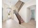 Grand foyer with staircase, tile floors and decorative glass front door letting in plenty of light at 1012 Bradberry Dr, Nokomis, FL 34275