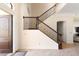 Bright foyer featuring a staircase with decorative wrought iron spindles and an inviting front door at 1012 Bradberry Dr, Nokomis, FL 34275
