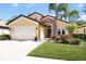 Charming single Gathering home featuring an attached two car garage, manicured lawn, and tasteful landscaping at 1012 Bradberry Dr, Nokomis, FL 34275