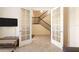 Living room with tile flooring, a view of the staircase, and a glass paneled door at 1012 Bradberry Dr, Nokomis, FL 34275