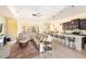 Open concept floor plan featuring a living room with a decorative ceiling fan and an adjacent kitchen with a marble island at 1012 Bradberry Dr, Nokomis, FL 34275