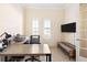 Modern office space featuring a large desk, neutral colors and arched windows at 1012 Bradberry Dr, Nokomis, FL 34275