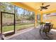 Outdoor screened in patio with brick flooring, a ceiling fan, and views of the backyard at 1012 Bradberry Dr, Nokomis, FL 34275