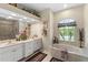 Elegant bathroom with double vanity, garden tub, and separate shower at 14089 Newson Ln, Port Charlotte, FL 33981
