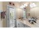 Clean bathroom with a single sink vanity and access to the backyard at 14089 Newson Ln, Port Charlotte, FL 33981