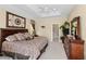 Main bedroom with king-size bed, dresser and access to bathroom at 14089 Newson Ln, Port Charlotte, FL 33981