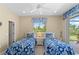 Charming bedroom with twin beds and access to a private patio at 14089 Newson Ln, Port Charlotte, FL 33981