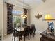 Formal dining room with a wood table and access to the outdoors at 14089 Newson Ln, Port Charlotte, FL 33981