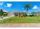 House exterior view, showcasing a two-car garage and manicured lawn at 14089 Newson Ln, Port Charlotte, FL 33981