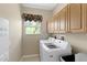 Well-lit laundry room with washer, dryer, and ample cabinet space at 14089 Newson Ln, Port Charlotte, FL 33981