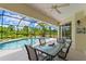 Relaxing screened pool area with patio furniture and lush landscaping at 14089 Newson Ln, Port Charlotte, FL 33981