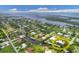 Aerial view of a coastal community with waterfront homes, canals, and access to open water at 200 Capstan Dr, Placida, FL 33946